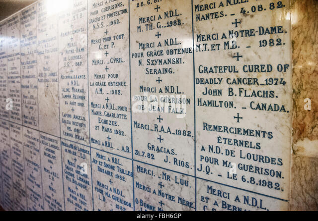 votive-tablets-in-the-hallway-to-the-crypt-of-lourdes-fbh6gp.jpg