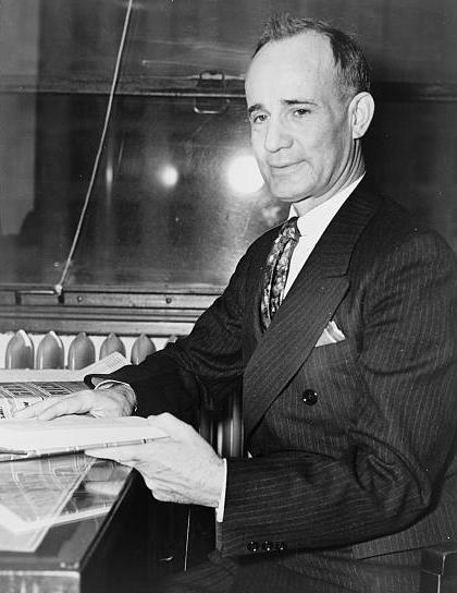 Napoleon Hill Seated With Book Tgr